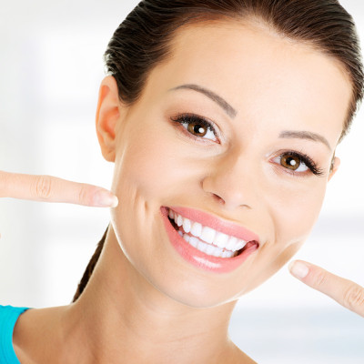 Woman showing her perfect straight white teeth.